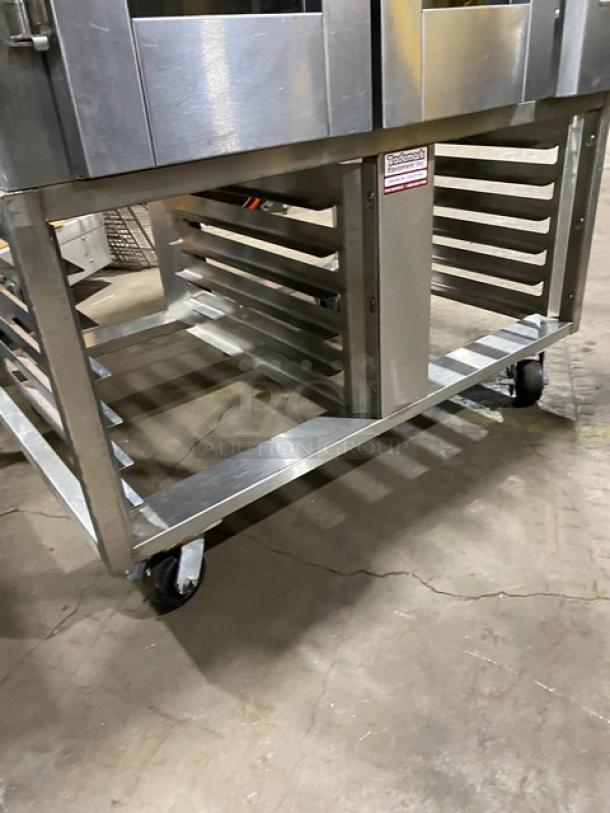 Baxter OV300G stainless steel convection oven with digital controls, 8-pan rotating rack, and open-base pan storage on casters.