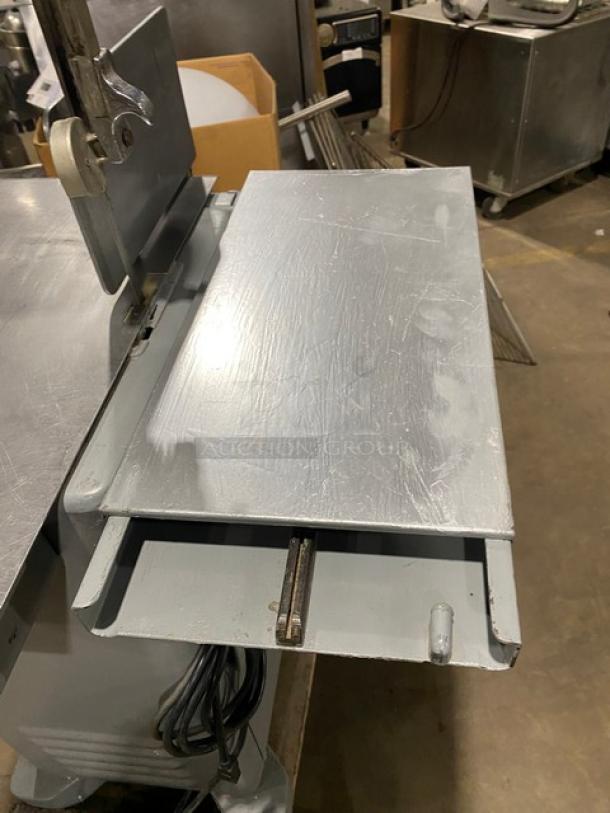 Biro Model 22 commercial stainless steel electric meat saw with portion control slide-top table, on sturdy legs, SN: 2216727.