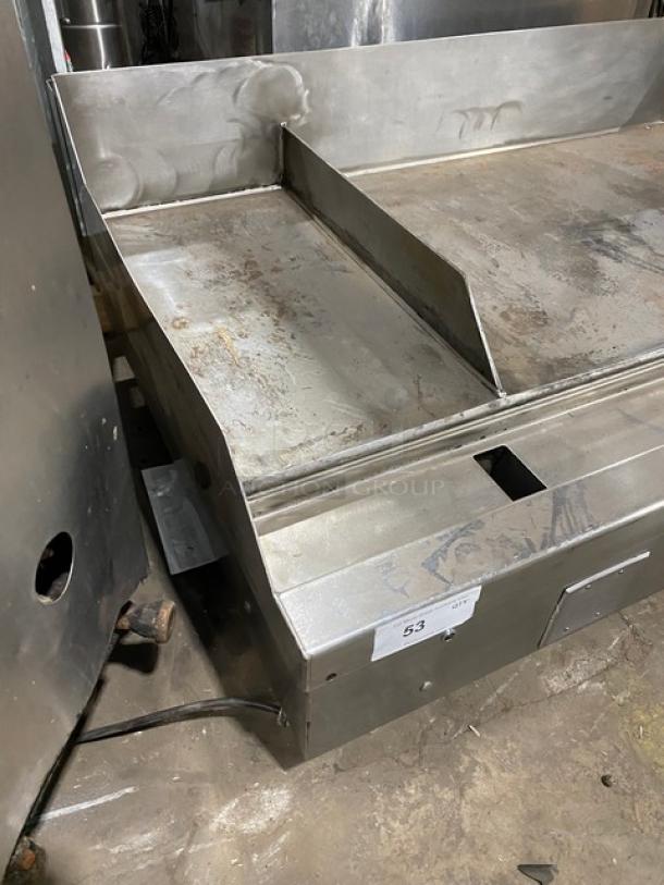 Woodstone 48" stainless steel natural gas griddle. Split-top, back and side splash, mounted on legs. Used condition.