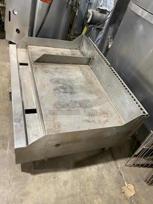 Woodstone stainless steel natural gas countertop 48" split-top plancha griddle with back and side splash, on legs.