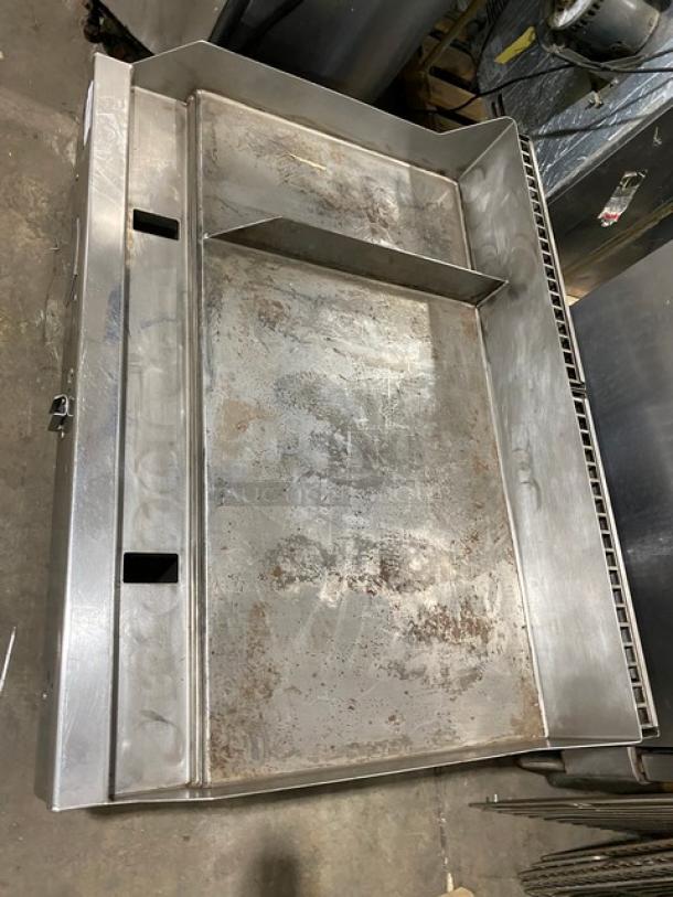 Woodstone commercial stainless steel 48" split-top natural gas griddle, with back and side splash, on legs; some surface wear.
