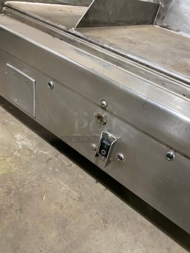 Woodstone 48" stainless steel split-top plancha griddle, natural gas, countertop, with back and side splash, on legs.