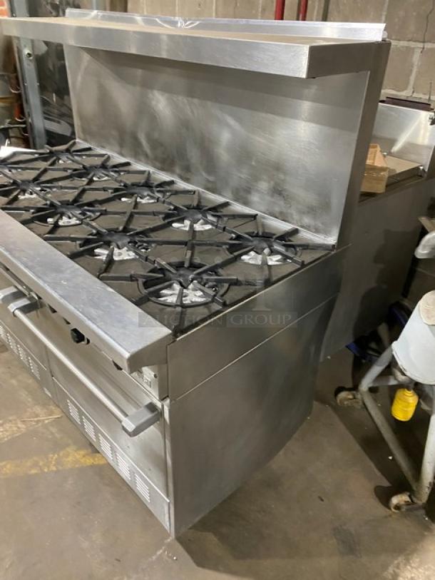Garland H284 stainless steel 10 burner range with double ovens, backsplash, overhead salamander shelf, and wired oven rack.
