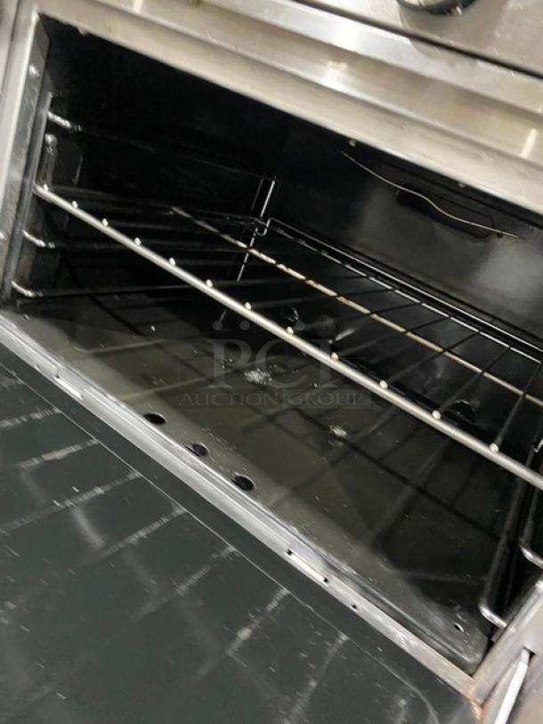 Garland H284 stainless steel oven interior with wired rack, part of a 10-burner range. Clean, spacious, commercial-grade.