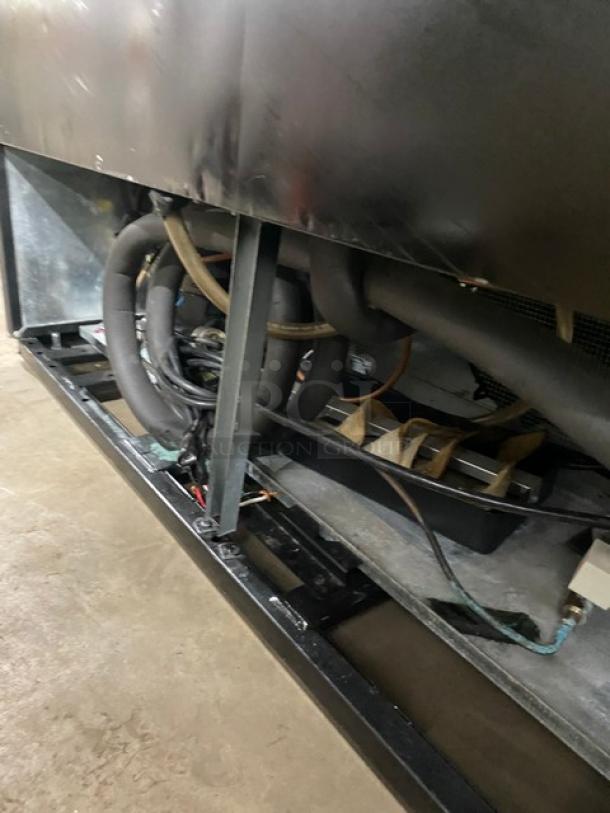 True GDM-49F-LD merchandiser freezer underside showing wiring and piping. Energy Star certified, commercial use.