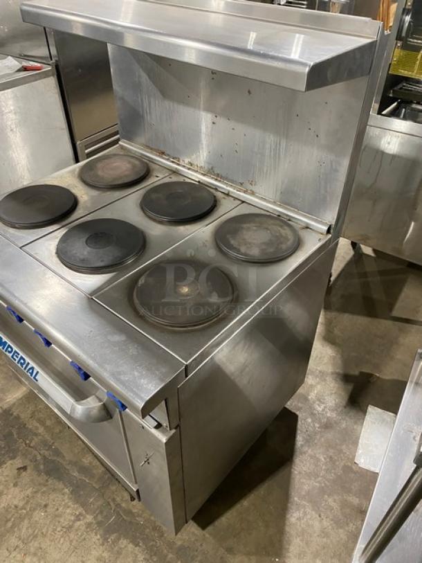 Imperial stainless steel electric 6-burner range with oven, backsplash, and overhead salamander shelf. Includes wired oven rack.