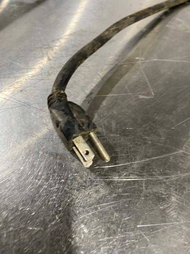 Close-up of a worn power plug from the Moffat stainless steel electric convection oven, showing its condition.