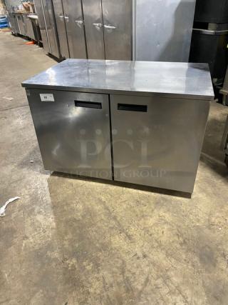 Delfield UC4048STAR stainless steel 2-door refrigerated worktop table on casters, Energy Star certified, with poly coated wired rack.