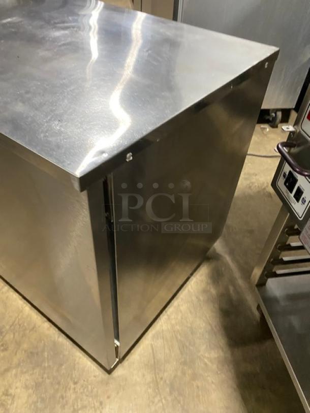 Delfield stainless steel 2-door refrigerated worktop table, model UC4048STAR, Energy Star certified, with poly coated rack, on casters.
