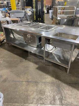 Stainless steel food prep table with 1 hot and 4 cold wells, adapter plates, and undershelf. On legs, commercial-grade.