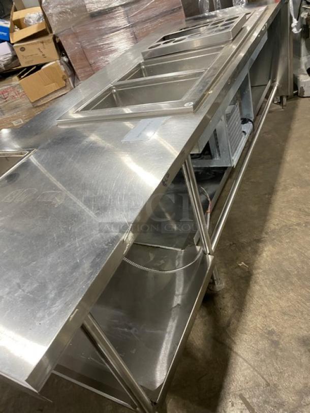 Custom stainless steel food prep table, single-well hot, four-well cold, with adapter plates and undershelf. On legs.