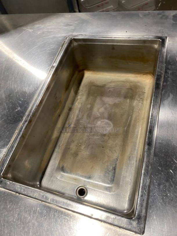 Custom stainless steel food prep table featuring a single-well hot and four-well cold configuration, with adapter plates and undershelf.