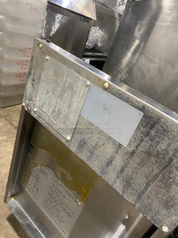Atosa commercial stainless steel natural gas deep fat fryer with back splash and basket hanger, on legs, shown in used condition.