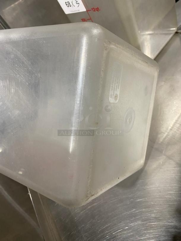 Cambro commercial clear polycarbonate 22 qt. food container, used condition, visible label with measurement markings.