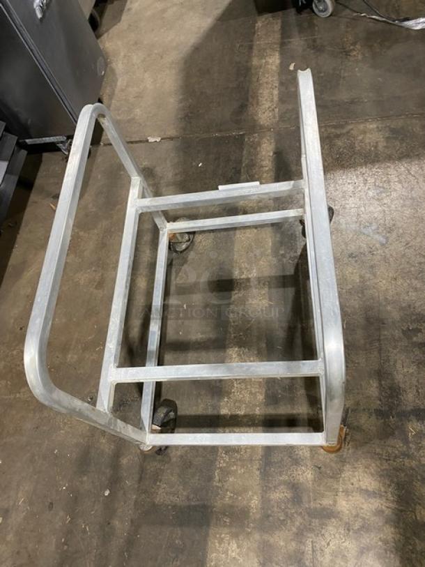 Commercial heavy-duty utility cart on casters, metal frame, open top, used condition, ideal for bulk moving tasks.