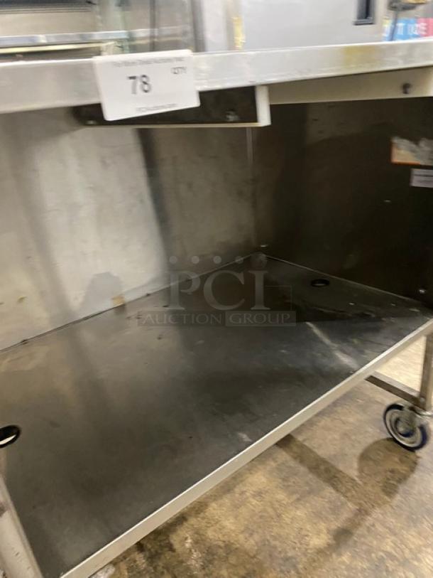 Commercial stainless steel dry enclosed-base worktop/prep table with double foldable shelf on casters, used condition.