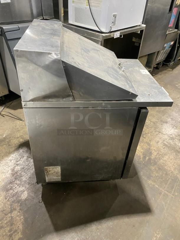 True stainless steel single door prep table, model TSSU-2712MB, on casters, commercial-grade, refrigerated.