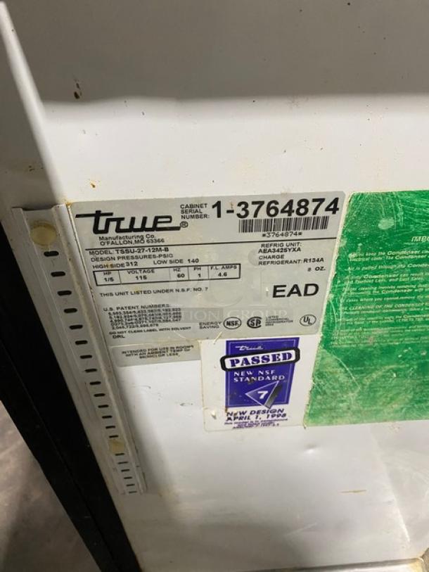 True TSSU-27-12M-B stainless steel refrigerated prep table, serial 1-3764874, on casters. Visible NSF and energy labels.