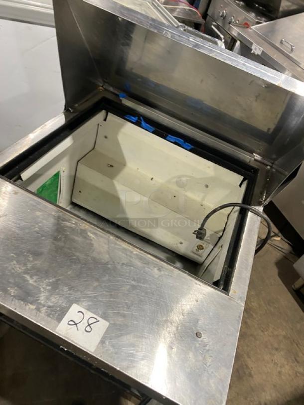 True commercial stainless steel refrigerated prep table, model TSSU-27-12M-B, on casters, with open top view.