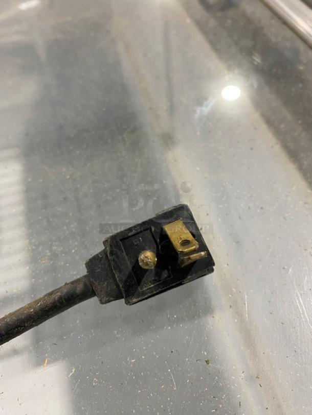 Close-up image of a plug for Electrolux KCG150LW0 display freezer, showing details and condition of the connection.