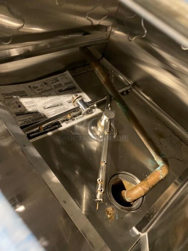CMA Energy-Mizer L-1C undercounter glasswasher interior, stainless steel, electric, 115V, with peg rack and visible manual.