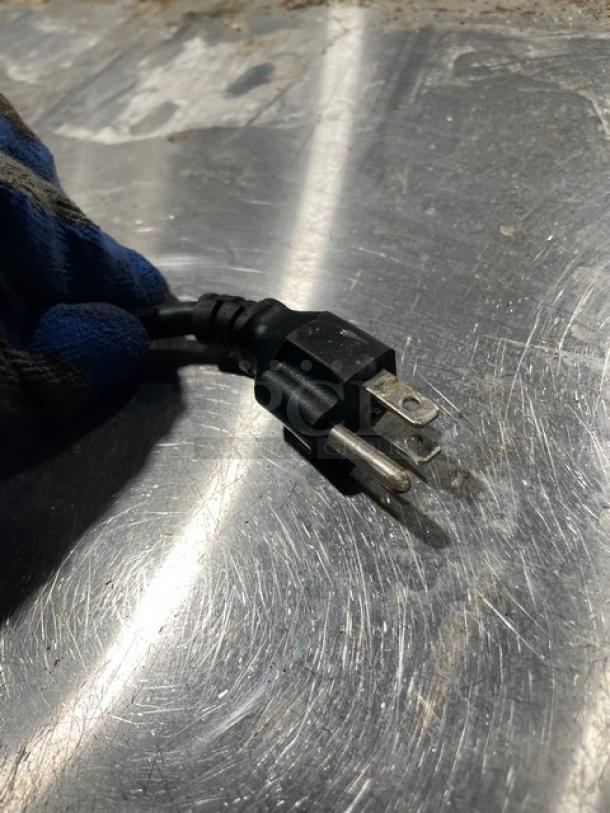 Close-up image of a power plug for the Avantco Model 178UDD60HCS kegerator, showing three prongs.