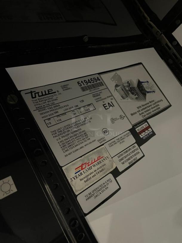 True TAC-30GS refrigerated open-air merchandiser case. Stainless steel with adjustable wire racks, model and warranty labels.