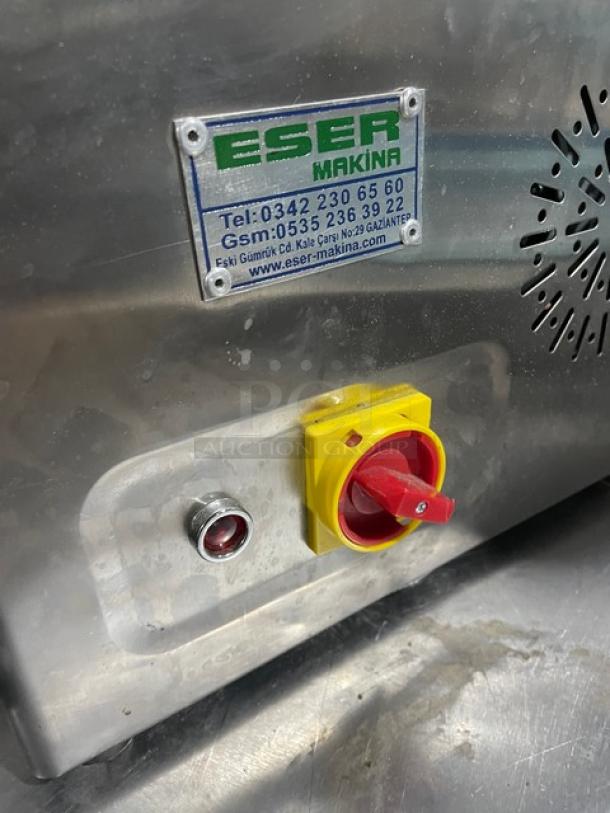 Eser Makina stainless steel electric meat grinder, commercial grade, visible power switch, and model label with contact info.