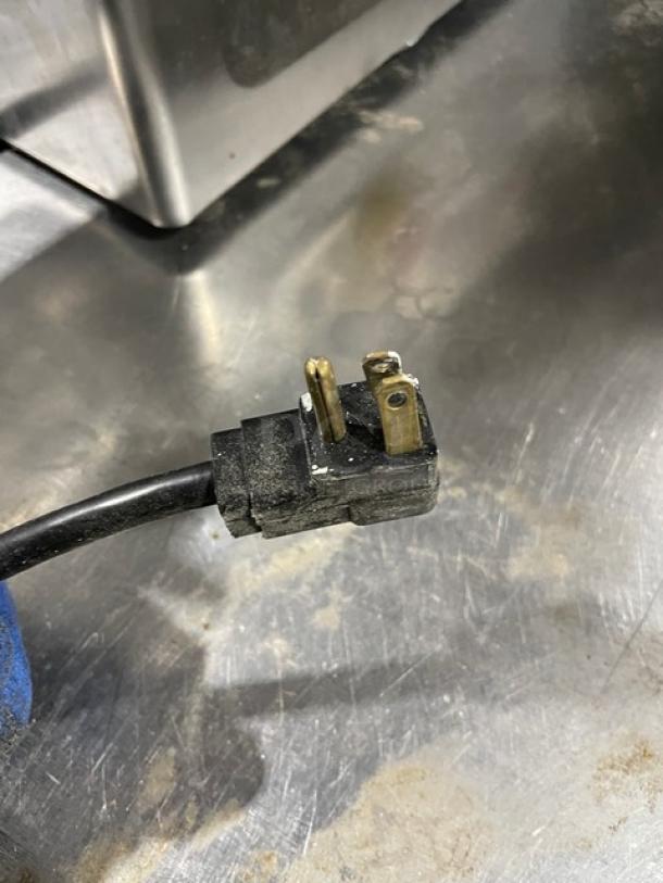 Eser Makina stainless steel electric meat grinder plug, showing three-prong connection on a countertop.