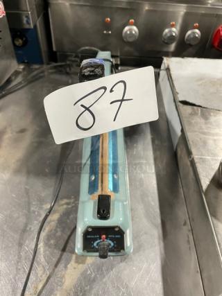 Commercial Electric Manual Impulse Sealer, Model 300, 110V/210-250V, in used condition. Model label visible on base.