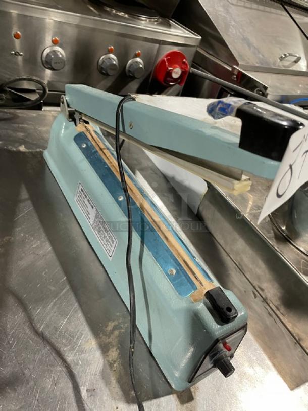 Commercial Electric Manual Impulse Sealer, Model 300, light blue, 110V/210-250V, with visible power switch and cord, used condition.