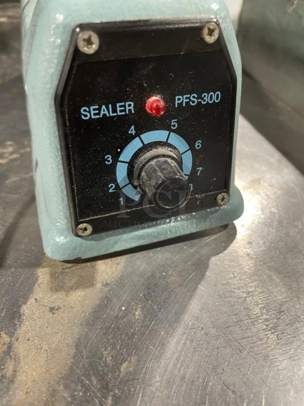 Commercial electric impulse sealer, Model PFS-300. Features adjustable dial, 110V/210-250V. Slight wear, used condition.