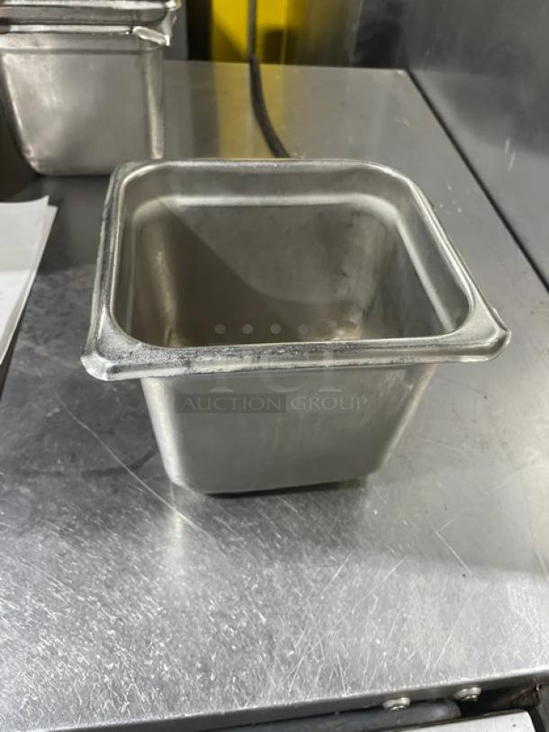 Commercial stainless steel hotel steamtable pan in good condition, square shape with reinforced corners. Industrial-grade kitchenware.