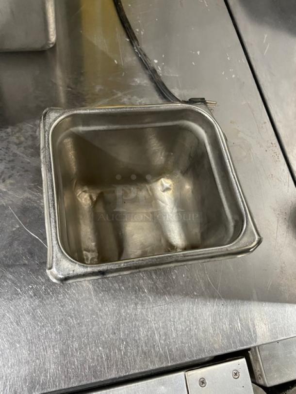 Stainless steel hotel steamtable pan, square shape, used condition, visible dents, ideal for commercial food service.