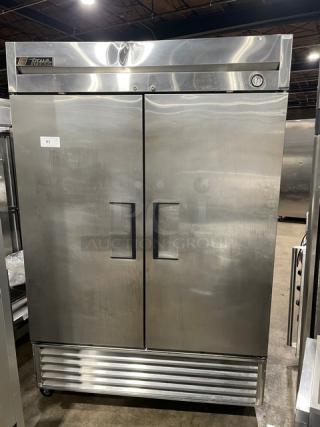 True T-49F commercial stainless steel 2-door reach-in freezer, poly coated racks, caster wheels, 115V, 1 phase.