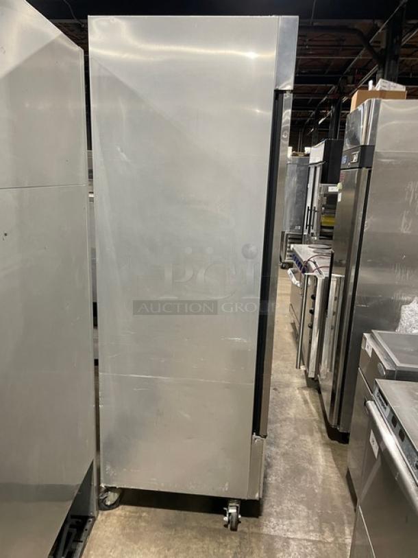 True T-49F Commercial Stainless Steel 2 Door Reach-In Freezer with poly-coated wire rack, 115V, on casters.