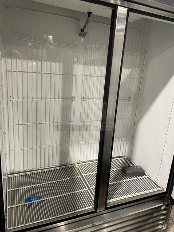 True T49F Commercial Stainless Steel 2 Door Reach-In Freezer with poly-coated wired racks, on casters, 115V, 1 phase.