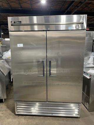 True T-49F commercial stainless steel 2-door reach-in freezer with poly-coated wired rack, in excellent condition.