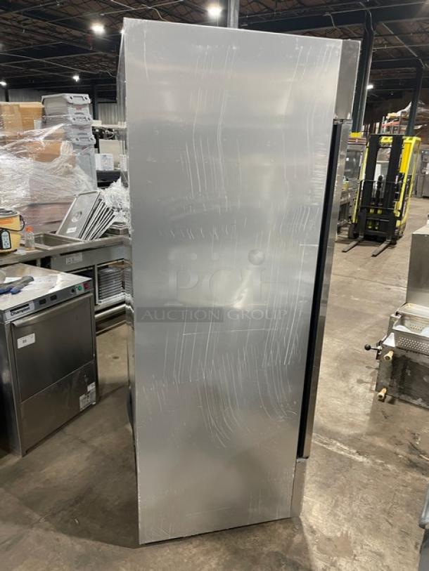 True T-49F commercial stainless steel 2-door reach-in freezer, scratched surface, poly-coated wire rack, 115V, 1 phase.