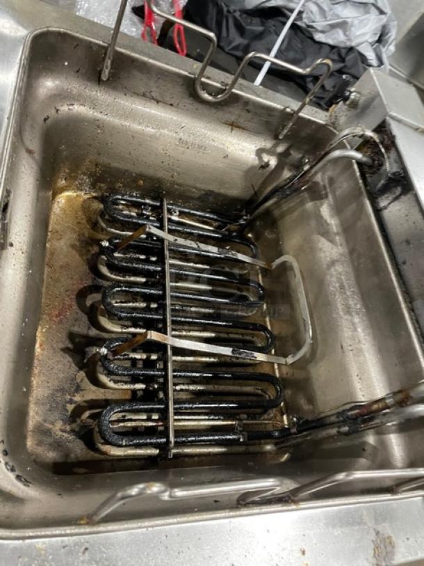 APW Wyott stainless steel electric countertop deep fryer with thermostatic control, shows wear, heating elements visible.
