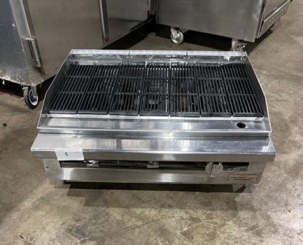 Therma-Tek stainless steel gas countertop char broiler with back and side splash. Features include a grill top and sturdy legs.