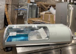 Marchia MSU140S 46" curved glass refrigerated sushi display with LED lights, double glass sliding doors, and new pans.