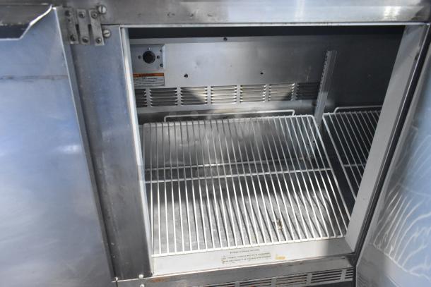 Beverage Air WTR72AY commercial stainless steel 3-door undercounter cooler, interior shelves, model label visible, on casters.
