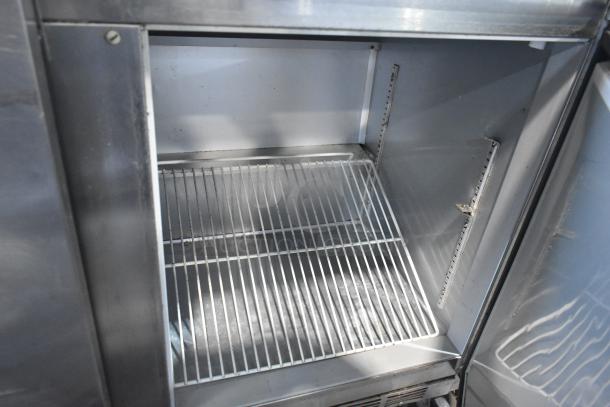 Beverage Air WTR72AY stainless steel 3-door commercial undercounter cooler on casters. Interior view, shelving visible.