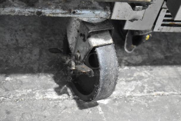 Beverage Air SPE72-30M caster wheel detail, showing wear and condition. Stainless prep table for commercial use, 115V.