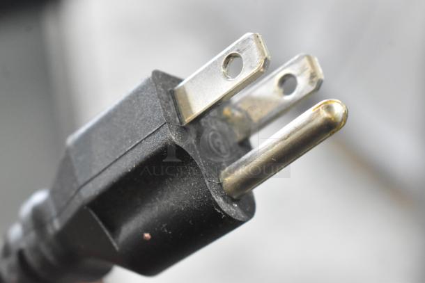 Close-up of a power plug for the 2023 Falcon ADC-163 deli display case, showing standard prongs.