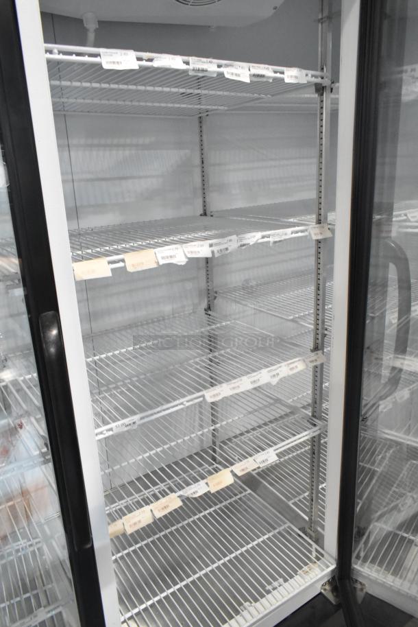 Master-Bilt MBGRP74-HG 3-door cooler merchandiser with poly-coated racks, metal build, 115/208-240V, 1 phase.