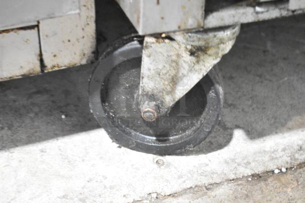 Beverage Air WTF27AHC-028 undercounter freezer caster, stainless steel body visible, on commercial floor, signs of wear.