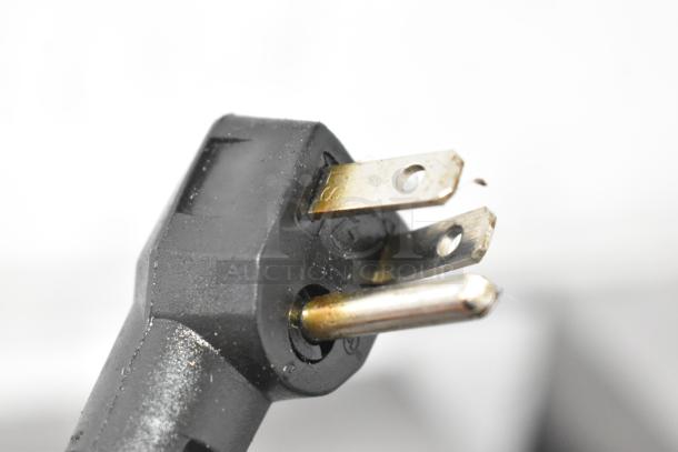 Close-up of a three-prong electrical plug for the Beverage Air WTF27AHC-028 freezer, highlighting its 115-volt compatibility.