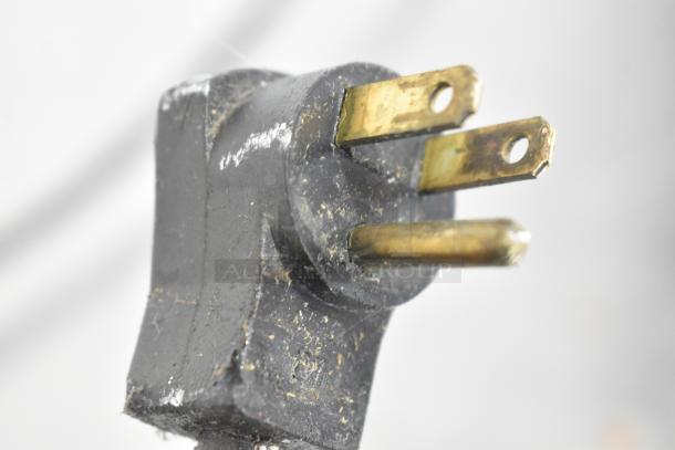 Close-up of a three-pronged plug, showing wear and slight discoloration. Part of the Beverage Air WTR60A cooler.